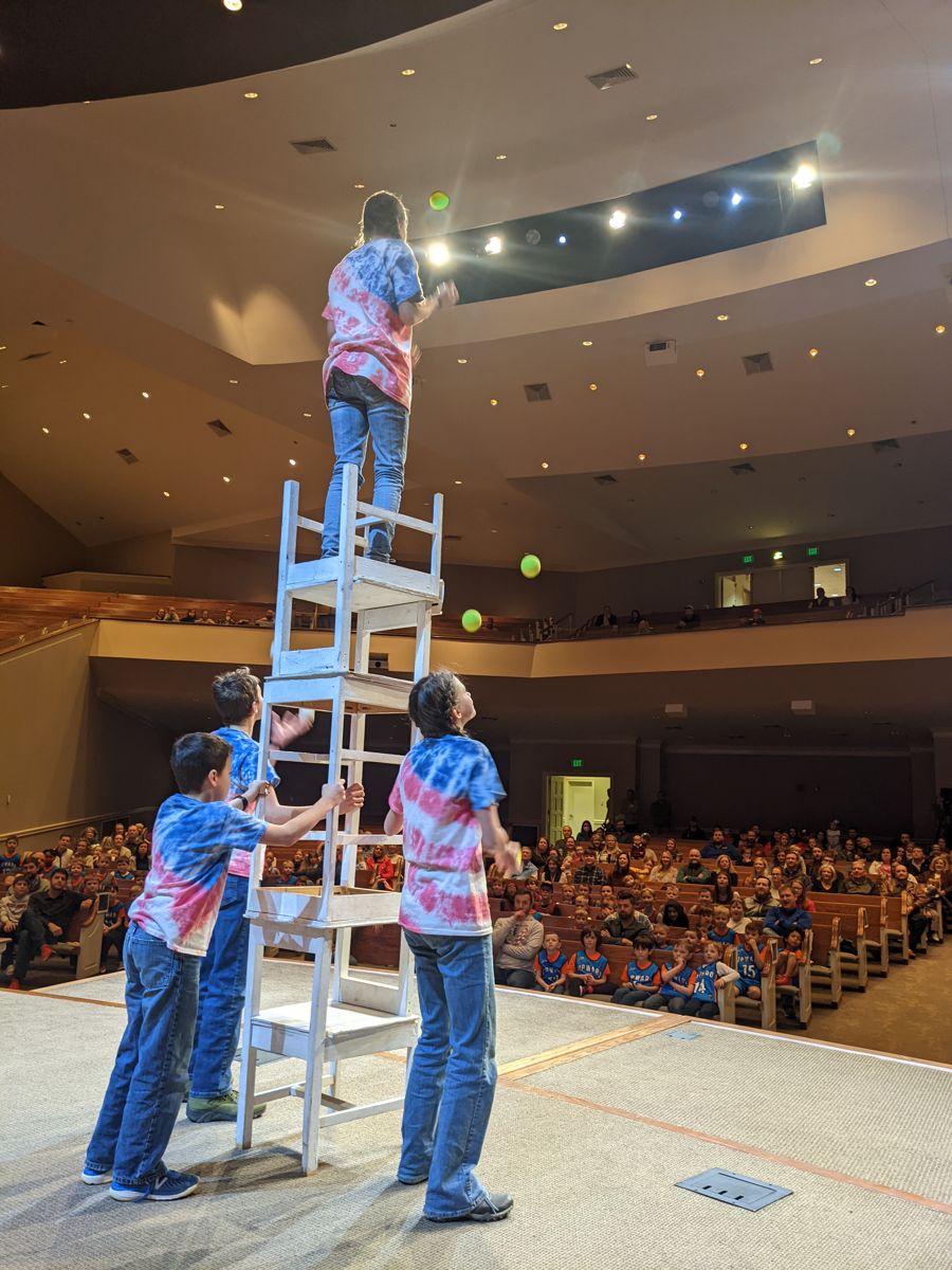 Dorrell family balancing on stacked chairs